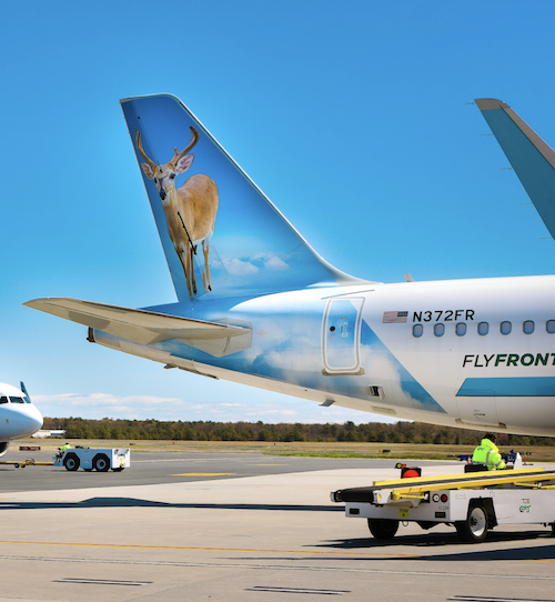 A Frontier Airplane with a deer painted on the tail