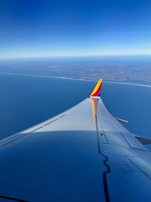 A Southwest airplane wing in the sky