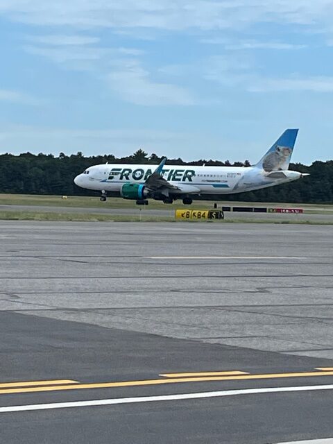 A Frontier plane on the runway at ISP Airport