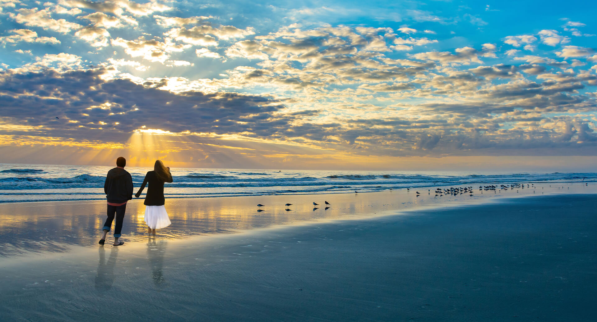 Couple walking on beach in Jacksonville, FL