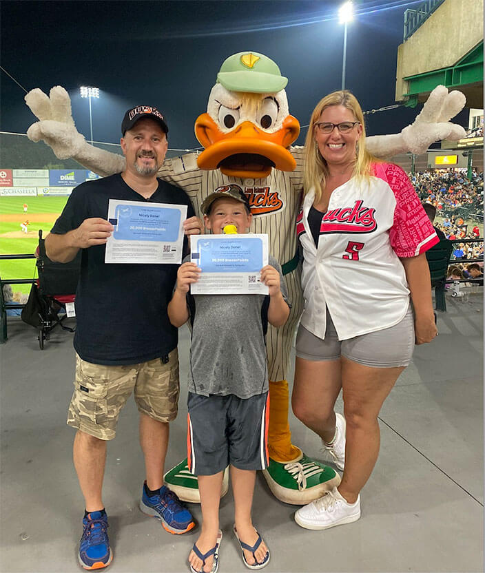 Duck baseball mascot posing for picture with family 